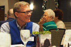 Saint Francis volunteer Gary Gaines visits with others during the annual volunteer luncheon.