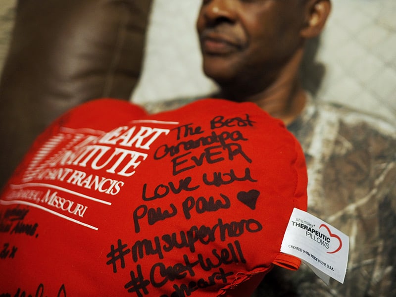 Calvin Box shows a pillow bearing well-wishes from family