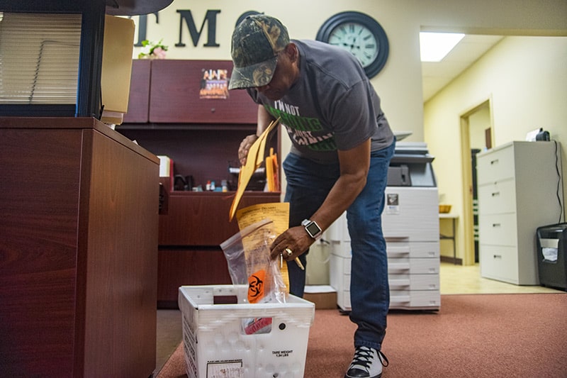 Calvin Box collects deliveries in an office