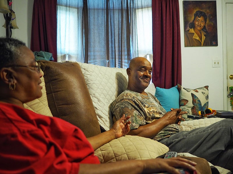 Calvin Box relaxes in his living room with his wife, Maria.
