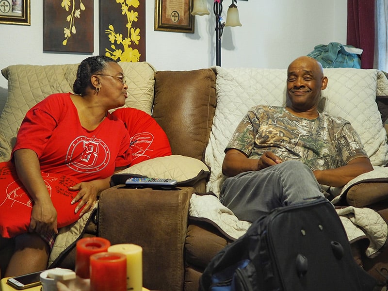 Calvin and Maria Box have a conversation in their living room.