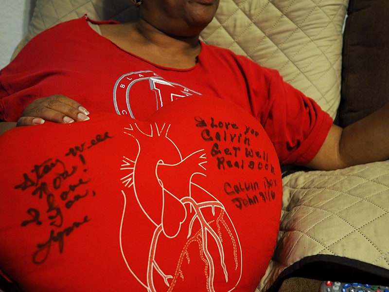 Maria Box shows the pillow signed by well-wishers.