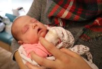 Baby Jovana is held by her mother in the NICU at Saint Francis Healthcare.