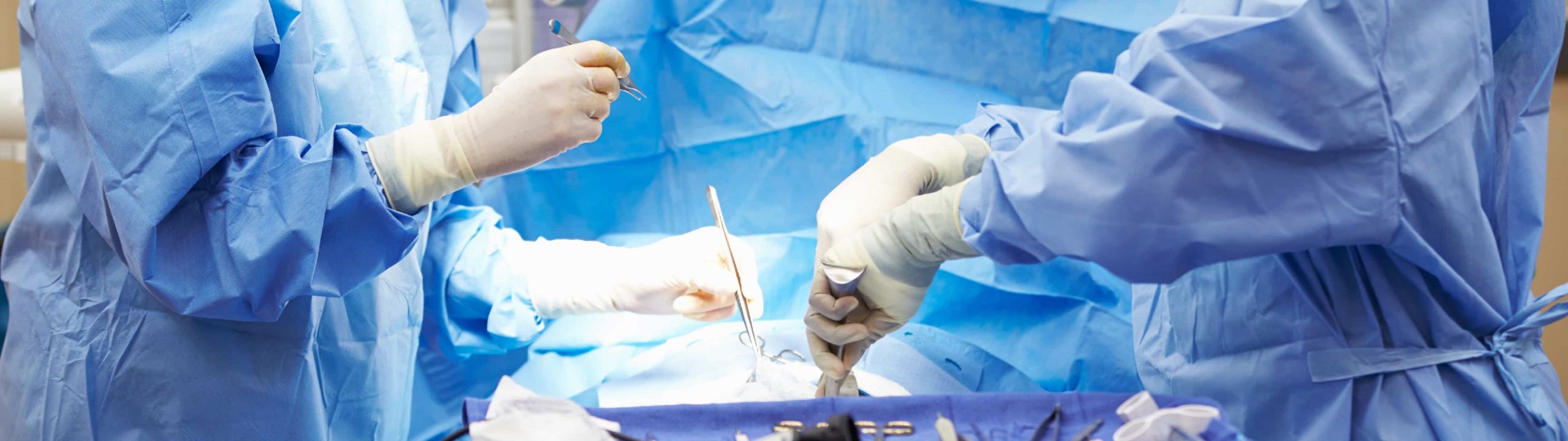 Surgeons operate on a patient in an operating room