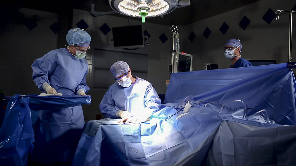 A physician performs surgery in an operating room at Saint Francis.