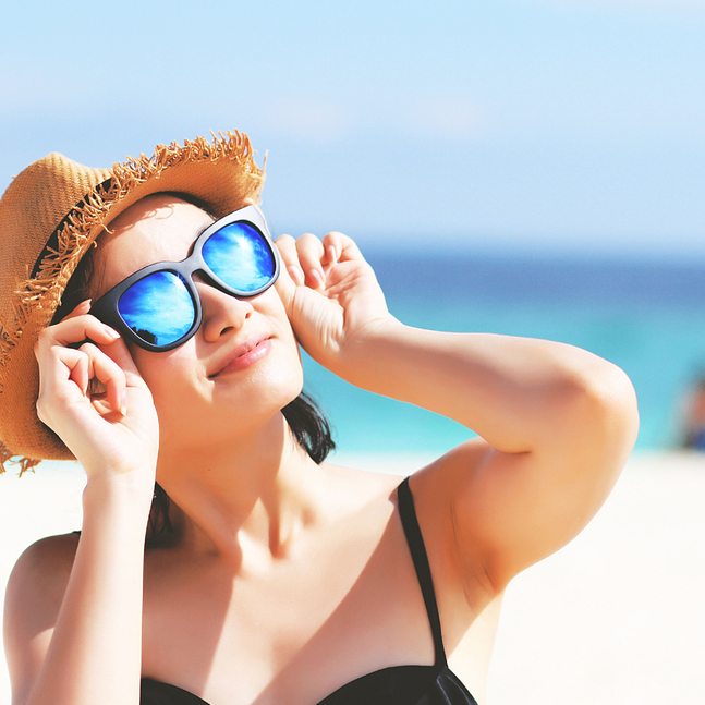 Woman at the beach in sunglasses