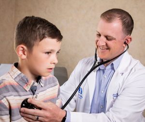 Dr. Andrew Boldrey examines a young patient