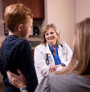 Rhonda Adams examines a young patient