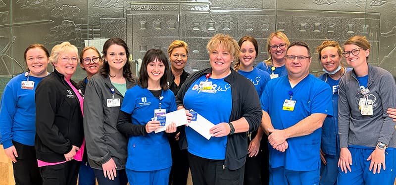 Taylor Ribbing McClard, PA and Julie Robinson, RN are presented with a Guardian Angel pin from Saint Francis Foundation.