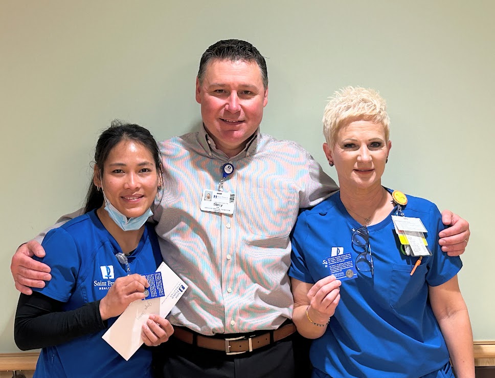 Joyce Shelty and Kathy Wray receive Guardian Angel pins from Stacy Huff.