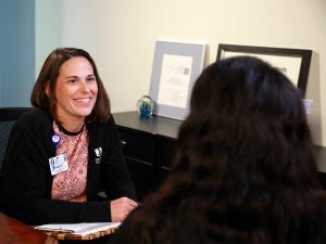 Genetic Counselor Melanie Baxter meets with a patient