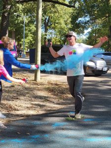 A runner crosses the finish line at Color Dash 2022