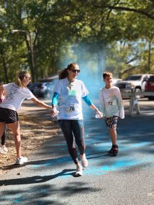 A runner crosses the finish line at Color Dash 2022