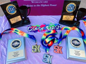 A table displaying medals and plaques from Color Dash 2022