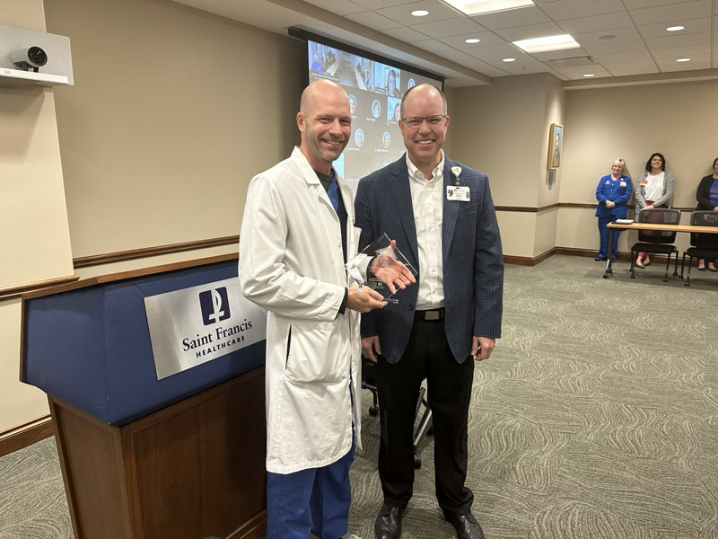 Saint Francis President and CEO Justin Davison presents the 2023 Sister Jane Award to Steven Joggerst, MD