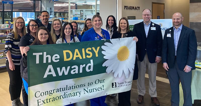 DAISY Award winner Johanna Chamness, RN, surrounded by colleagues and friends