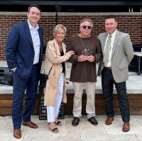 Lynn Richardet receives his award from Saint Francis Foundation Board President Garrett Ozbun, Robin Sims, and Saint Francis Foundation Executive Director Stacy Huff.