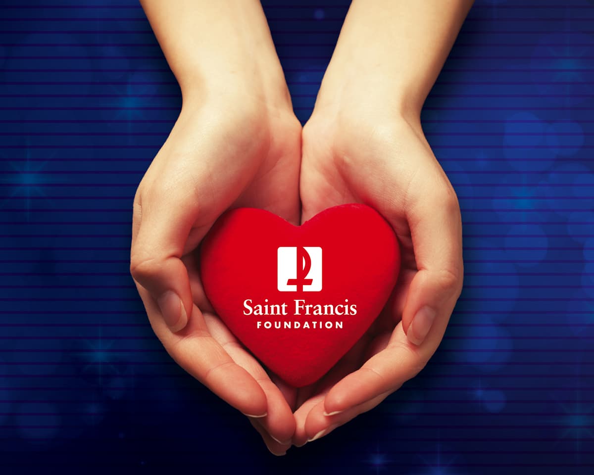 Hands holding a heart that is labeled Saint Francis Foundation