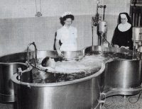 A polio patient rests in a therapy pool