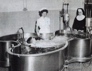 A polio patient rests in a therapy pool