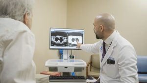 Hussein Asad, MD discusses scan results with a patient