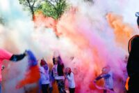 Color Dash participants run through clouds of colored powder