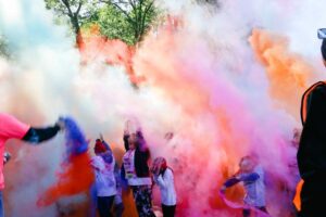 Color Dash participants run through clouds of colored powder